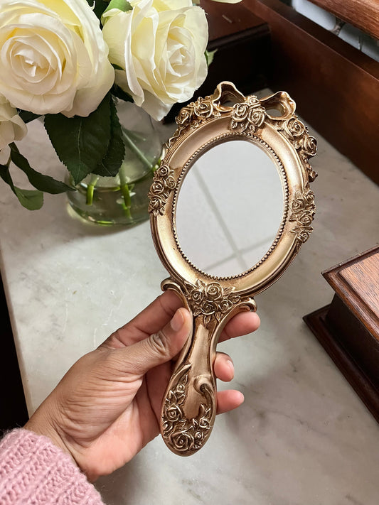 Vintage style rosette hand held vanity mirror