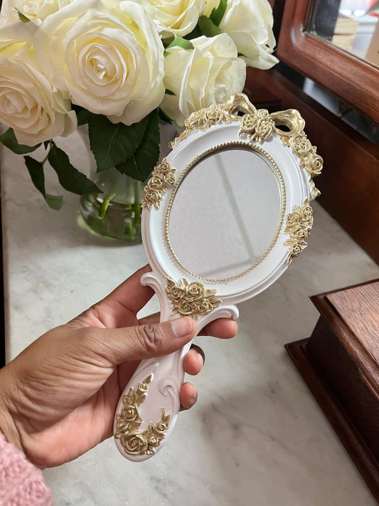 Vintage style rosette hand held vanity mirror